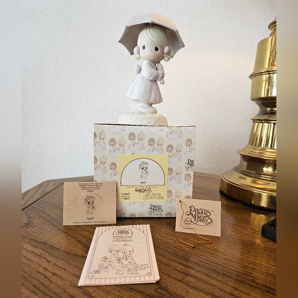Precious Moments "April" Porcelain figurine. New in the box with tags. 1987